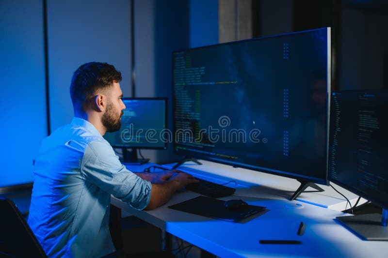 Smart skilled introvert tester write typing operating data security evening office dark room stock photos