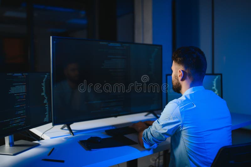 Smart skilled introvert tester write typing operating data security evening office dark room royalty free stock photos