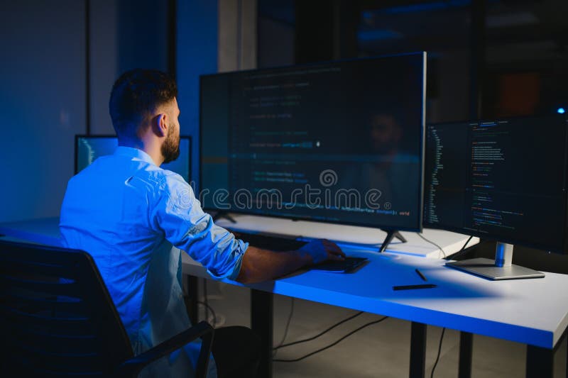 Smart skilled introvert tester write typing operating data security evening office dark room stock image
