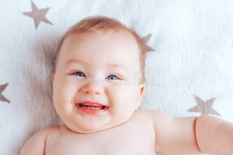 Photo Of A Smiling Baby A Newborn Baby With Blue Eyes And Blond Hair