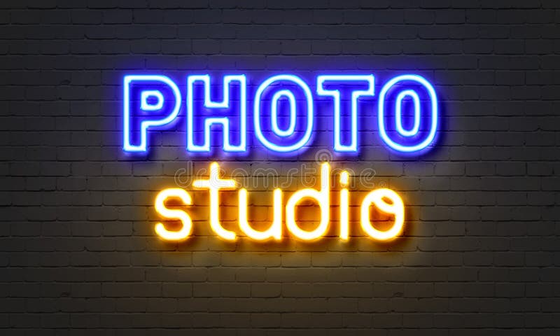 Photo Studio Neon Sign on Brick Wall Background. Stock Image - Image of