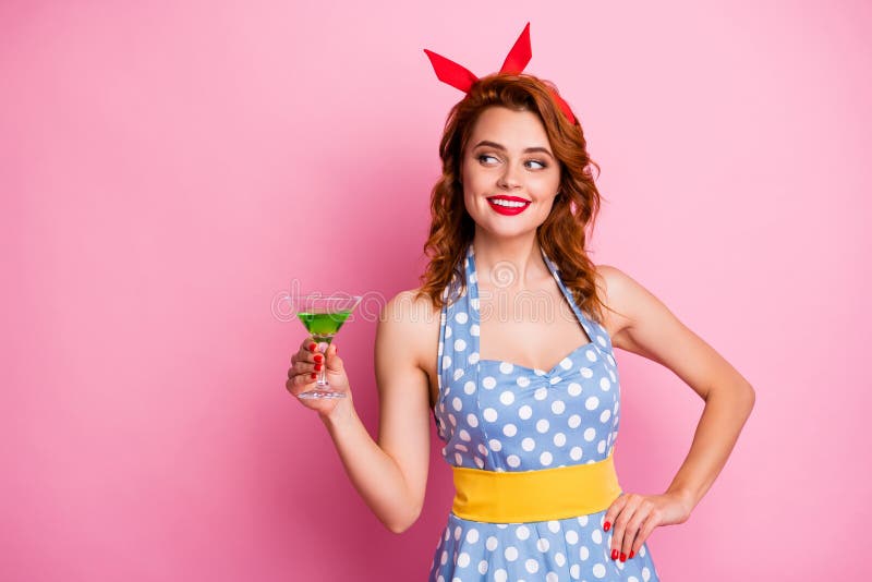 Photo of stunning lady hold green alcohol cocktail glass theme retro party look side empty space listen toast wear red