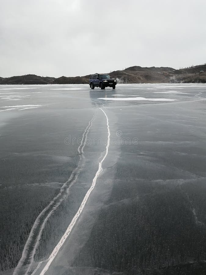 Driving on the frozen and cracked lake Baikal, Siberia, Russia stock photos