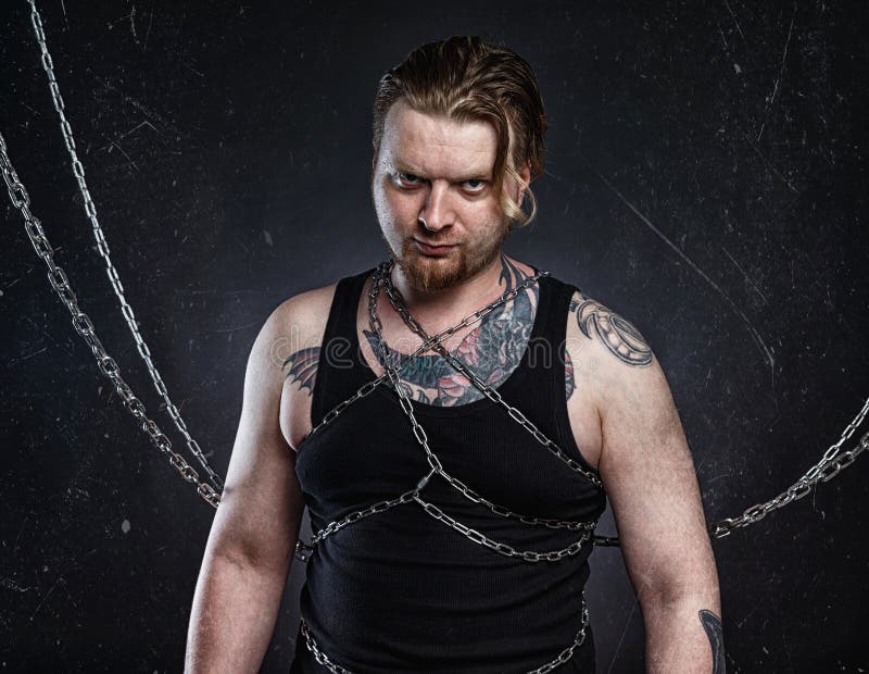 Photo of a Tattooed Young Blond Man Bound in Chains Stock Image Image