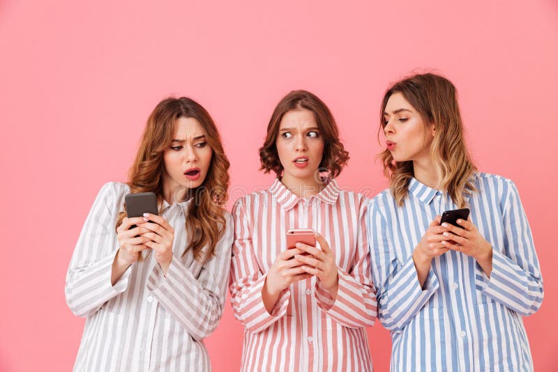 Photo of three women friends 20s wearing colorful striped pyjama stock photos Photo of three women friends 20s wearing colorful striped pyjama stock photos