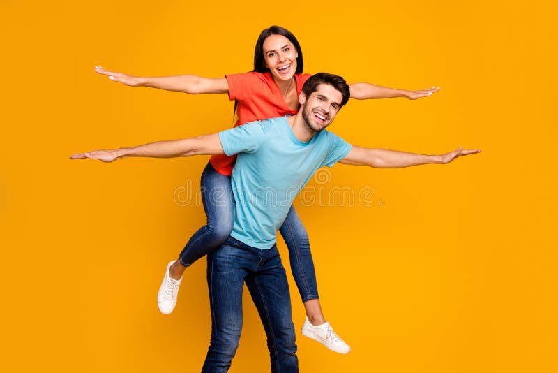 Photo of two funny people guy carry lady piggyback meet summer time together spread hands like wings wear casual stylish