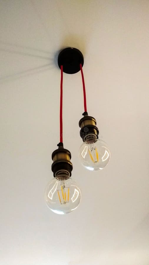 Photo of Two Light Bulbs Hanging from the Ceiling Stock Image Image