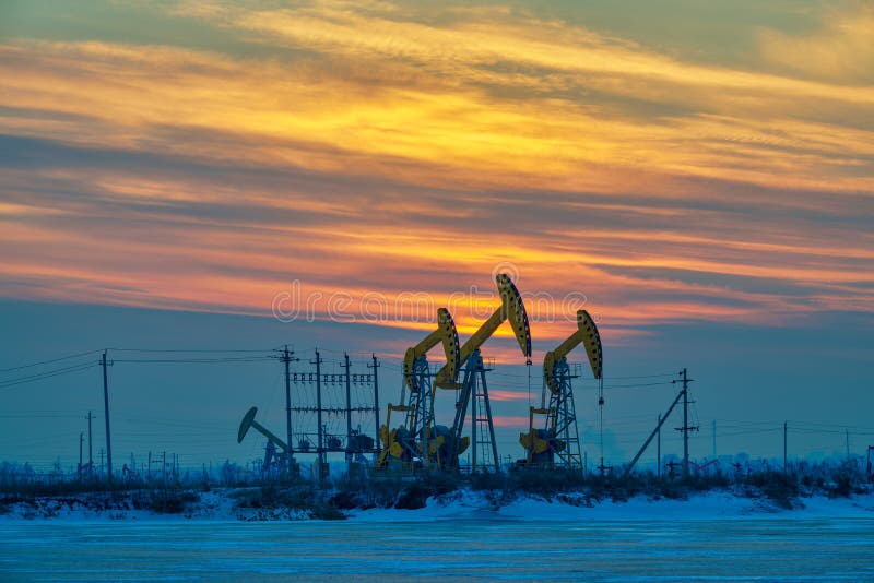 The pumping units sunset in winter in Daqing oil fields