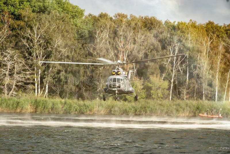 Military Mi-8 helicopter over the water.