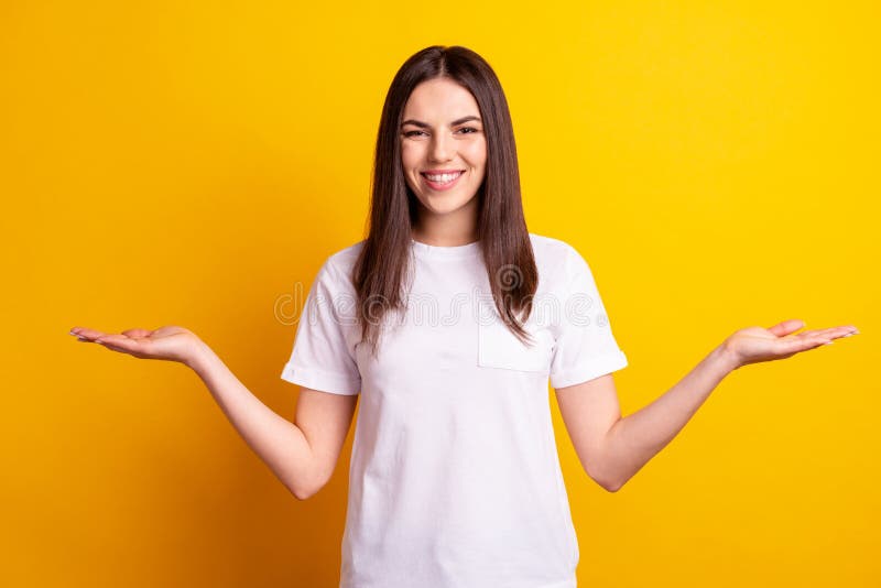 Photo of young attractive woman hold hands proposition advertise meausre isolated over yellow color background stock images