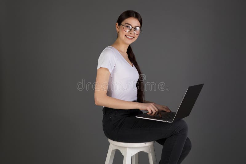 Photo of young brunete woman in white t-shirt, dark jeans and glasses stock photos Photo of young brunete woman in white t-shirt, dark jeans and glasses stock photos