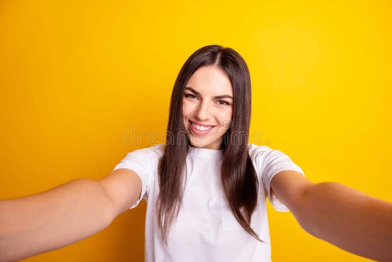 Photo of young cheerful girl good mood make selfie blogger wear casual outfit isolated over yellow color background stock photo