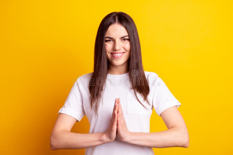 Photo of young cheerful girl meditate calm peaceful pleading dreamy isolated over yellow color background stock images