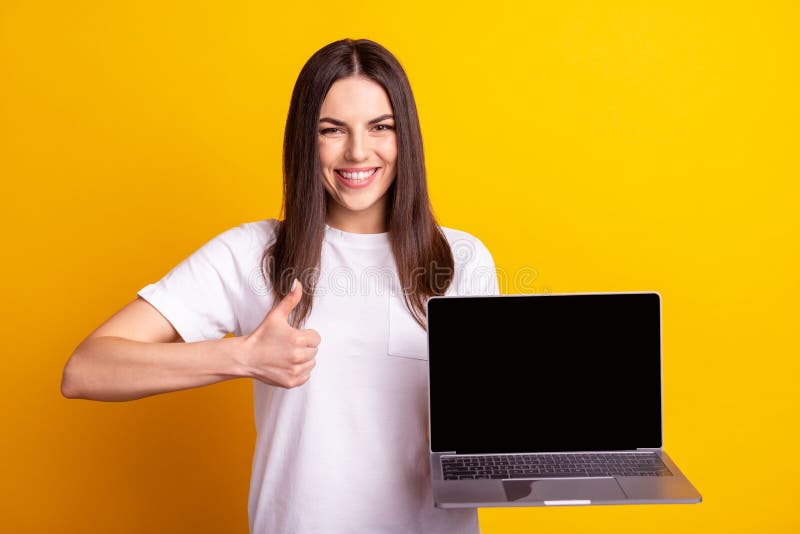 Photo of young pretty girl show thumb-up promoter ads promotion suggest isolated over yellow color background royalty free stock image