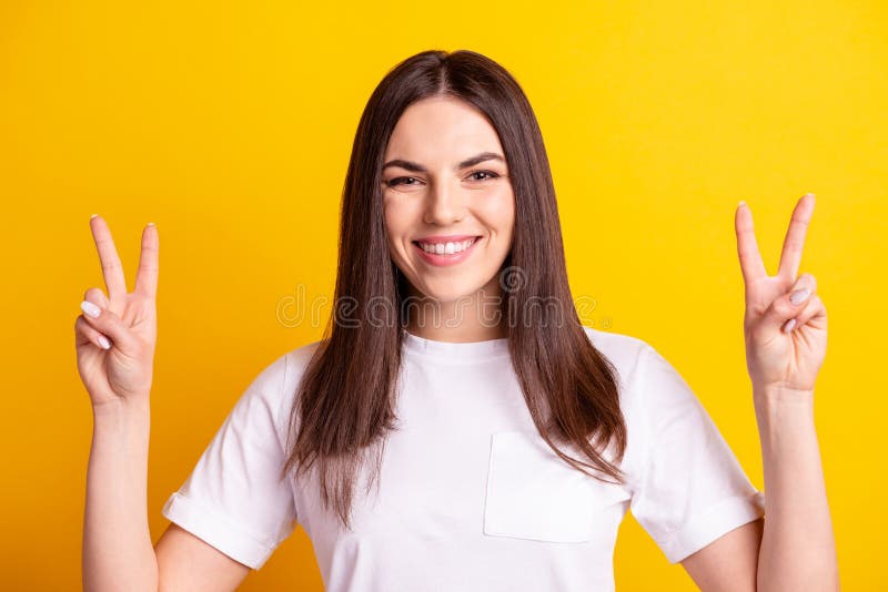 Photo of young pretty lady have fun show fingers victory v-symbol isolated over yellow color background stock images