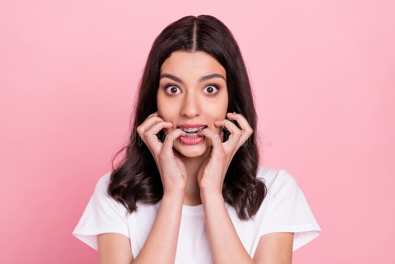 Photo of Young Scared Nervous Woman Bite Nails Fingers Teeth Braces on ...