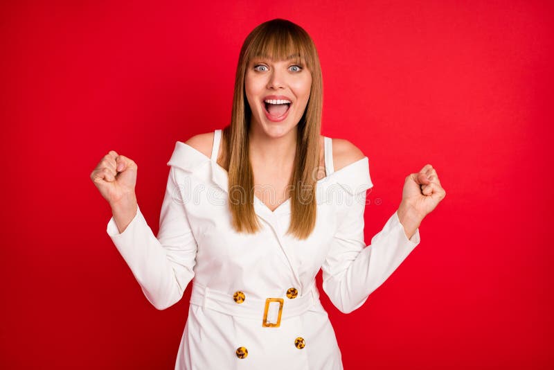 Photo of young woman happy positive smile rejoice victory lucky success fists hands isolated over red color background