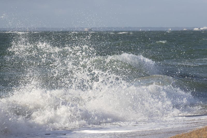 Waves crashing onto beach stock image. Image of ocean - 144136413