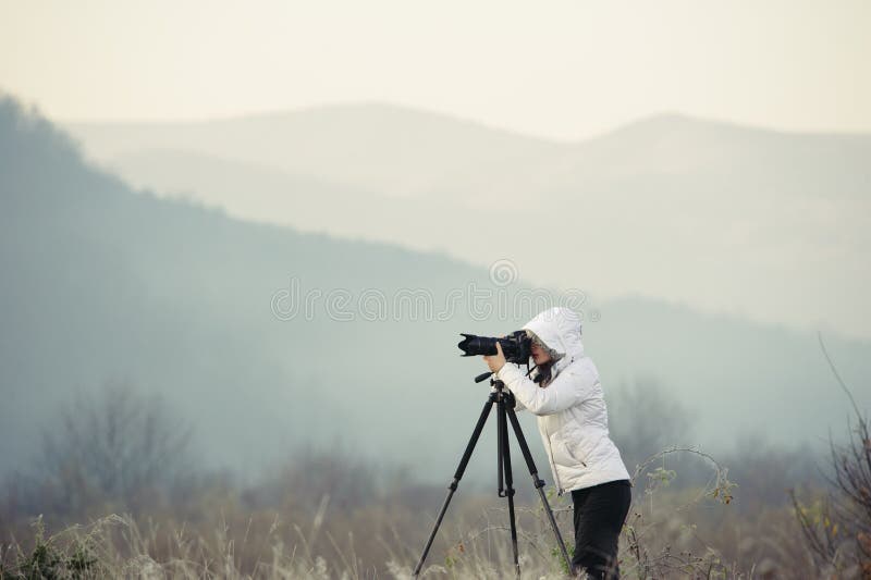 Photographer with Camera and Tripod Outdoor Taking Landscape Picture