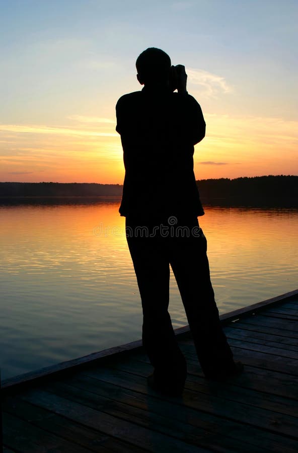 Photographer capturing sunset #2 royalty free stock photography