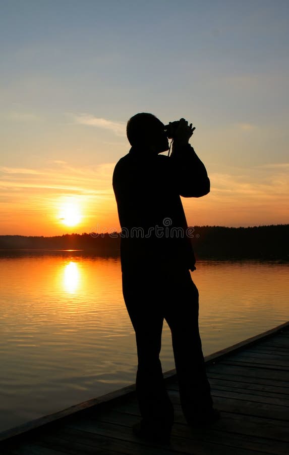 Photographer capturing sunset stock photo