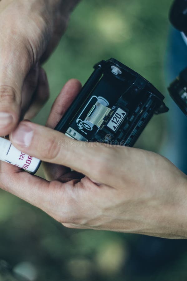 Photographer Loading Medium Format Film into the Film Back Stock Photo