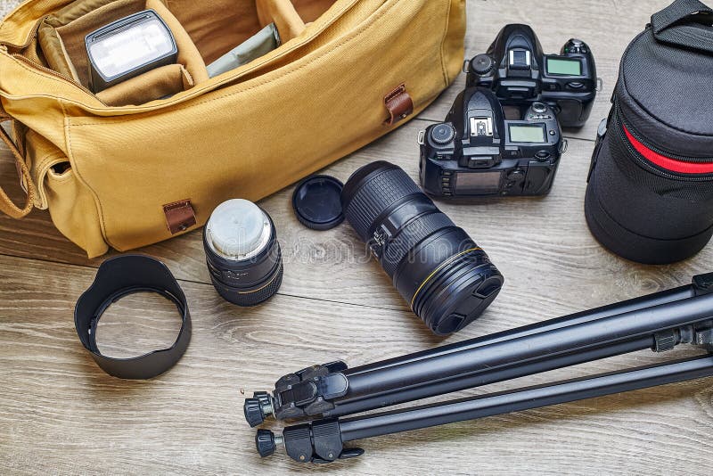 Photographer`s Bag with Cameras and Lenses is Ready for Packing Stock