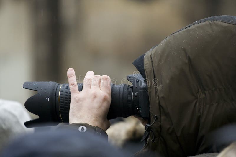 Photographer with telephoto lens