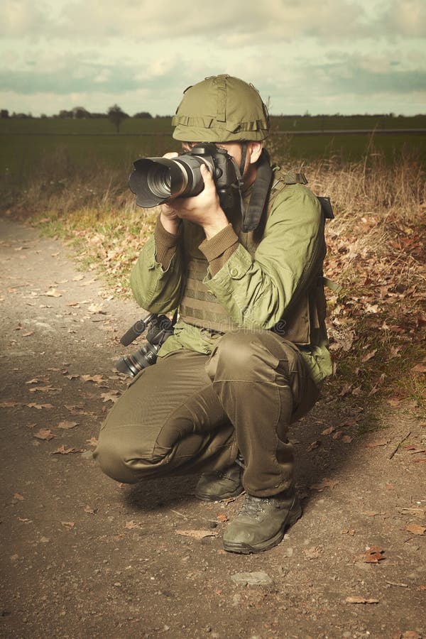Journalist photographer in war conflict zone taking pictures