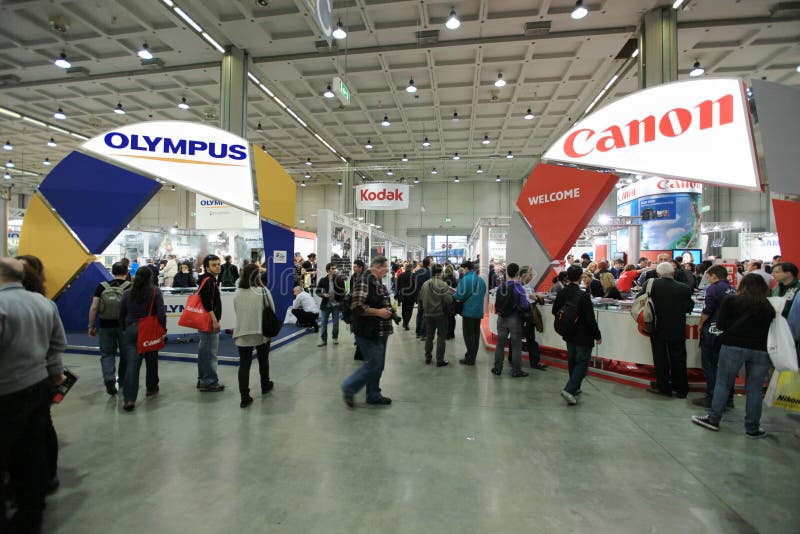 Close-up of people visiting stands looking for Olympus, Kodak and Canon products at Photoshow, international photo and digital imaging exhibition on March 26, 2011 in Milan, Italy. Close-up of people visiting stands looking for Olympus, Kodak and Canon products at Photoshow, international photo and digital imaging exhibition on March 26, 2011 in Milan, Italy.