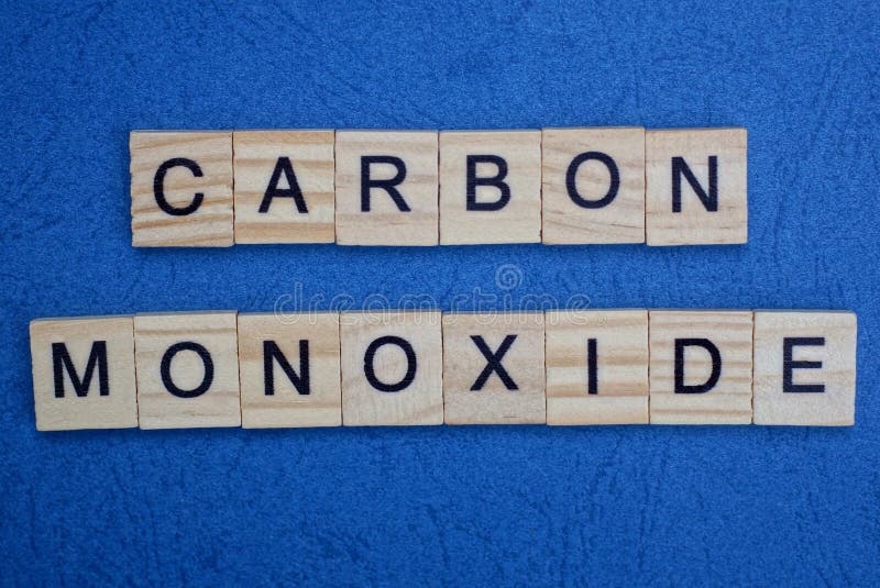 Phrase carbon monoxide made from gray wooden letters lies on a blue background