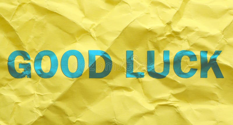 Phrase GOOD LUCK on yellow crumpled paper, top view royalty free stock photography