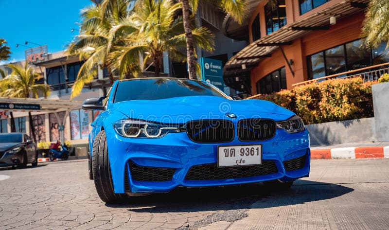 PHUKET, THAILAND- DECEMBER 25, 2023: Beautiful bright blue BMW M3 series in the parking lot. PHUKET, THAILAND- DECEMBER 25, 2023: Beautiful bright blue BMW M3 series in the parking lot