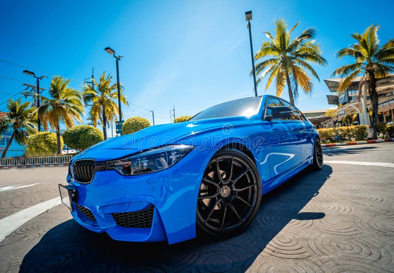 PHUKET, THAILAND- DECEMBER 25, 2023: Beautiful bright blue BMW M3 series in the parking lot. PHUKET, THAILAND- DECEMBER 25, 2023: Beautiful bright blue BMW M3 series in the parking lot