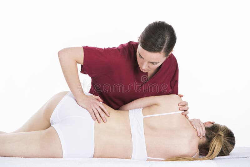 Physical therapist makes spinal mobilization to woman