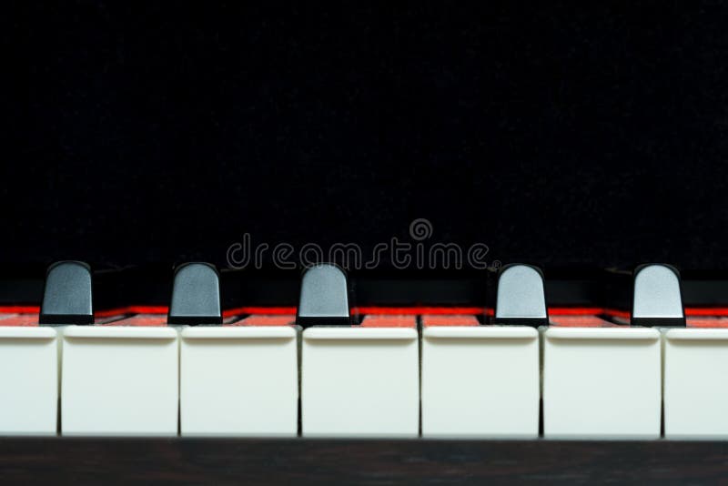 Piano keys front view on a black background, closeup stock photography