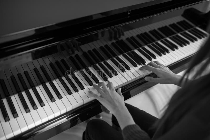 Piano music pianist hands playing. Musical instrument grand piano details with performer hand on white background royalty free stock photo Piano music pianist hands playing. Musical instrument grand piano details with performer hand on white background royalty free stock photo
