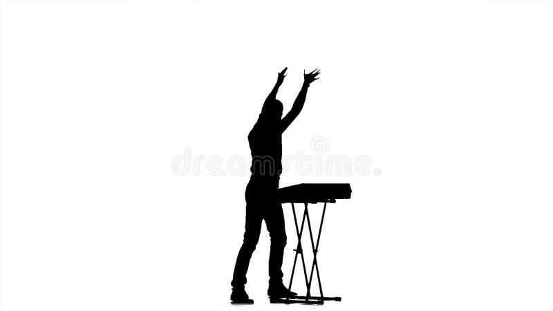 Piano playing. Man in half-turn. Silhouette. Slow motion