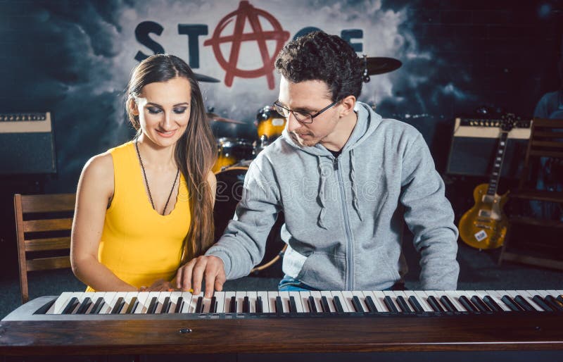 Piano Teacher Giving Music Lessons To His Student Stock Image Image Of Adult Musician 111494383
