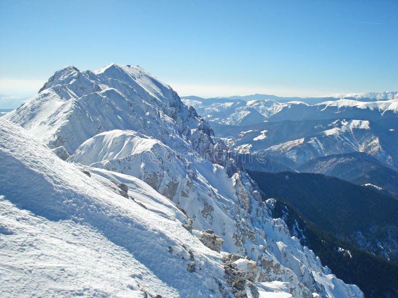 Piatra Craiului snow mountain ridge in witer with blue sky