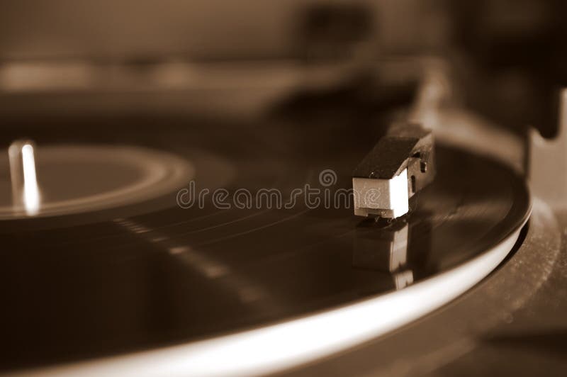 Turntable with record playing, sepia toned. Turntable with record playing, sepia toned