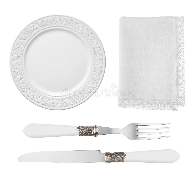 Piatto d'annata, coltello, forcella e tovagliolo isolati su fondo bianco fotografia stock libera da diritti Piatto d'annata, coltello, forcella e tovagliolo isolati su fondo bianco fotografia stock libera da diritti