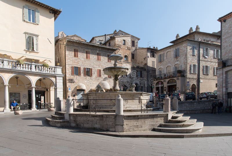 Piazza Del Comune in Assisi with a Stone Fountain, Civic Tower and ...