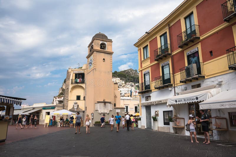 Capri, Italy - August 31, 2016: Tourists visit Piazza Umberto I, the most famous square of the island of Capri. Capri, Italy - August 31, 2016: Tourists visit Piazza Umberto I, the most famous square of the island of Capri.