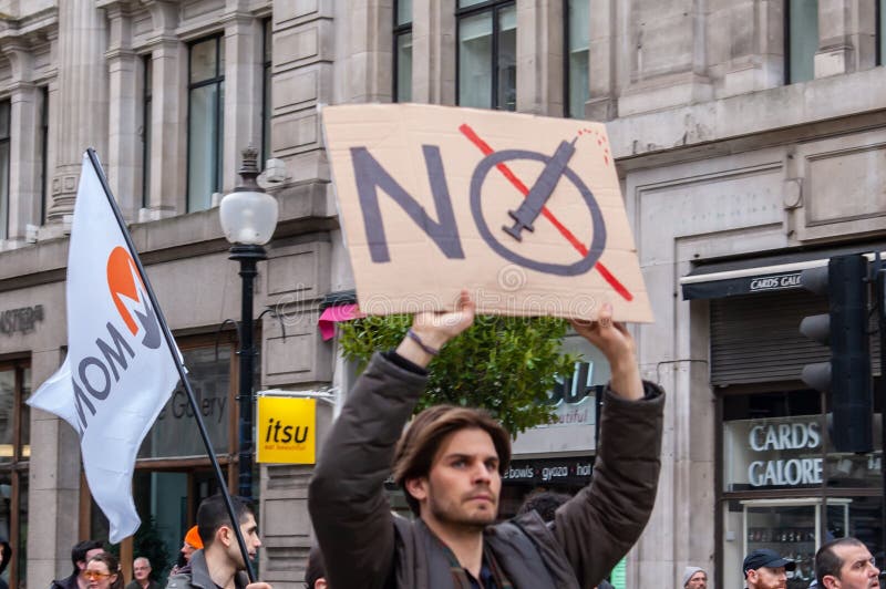 PICCADILLY, LONDON, ENGLAND- 20 March 2021: Protester with an anti-vaccine placard at the Vigil for the Voiceless anti-lockdown