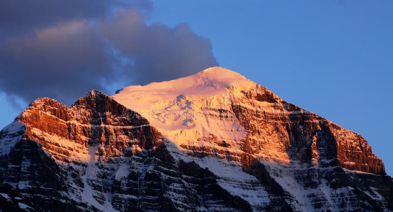 Golden snow mountain peaks in lake louise area at sunset moment, banff national park, alberta, canada. Golden snow mountain peaks in lake louise area at sunset moment, banff national park, alberta, canada