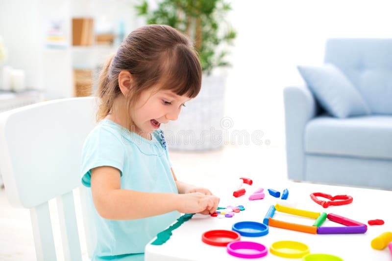 Piccola bella ragazza sorridente scolpire nuova casa di plasticine Creatività dei bambini Infanzia felice Sogni di inaugurazione fotografia stock libera da diritti Piccola bella ragazza sorridente scolpire nuova casa di plasticine Creatività dei bambini Infanzia felice Sogni di inaugurazione fotografia stock libera da diritti
