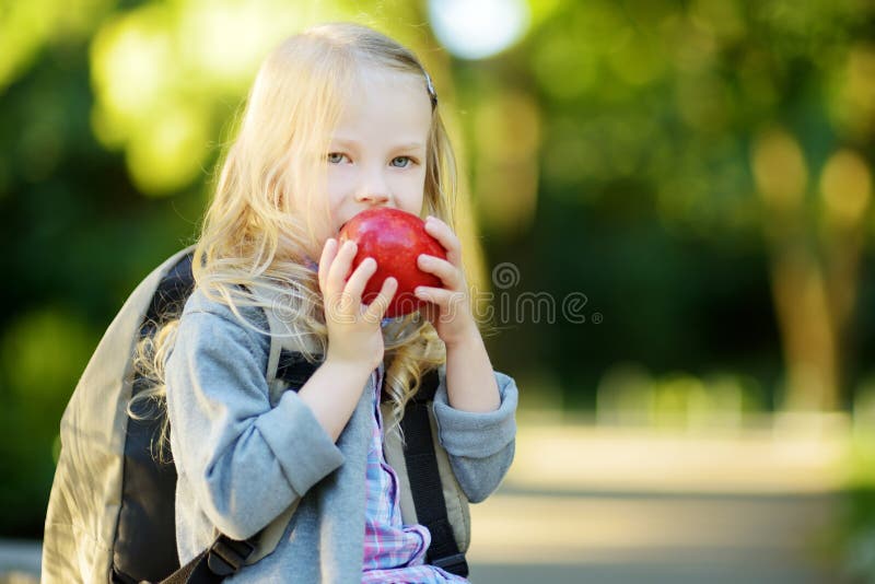 Piccola scolara adorabile che studia all'aperto il giorno luminoso di autunno Giovane studente che fa il suo compito Istruzione p fotografia stock Piccola scolara adorabile che studia all'aperto il giorno luminoso di autunno Giovane studente che fa il suo compito Istruzione p fotografia stock