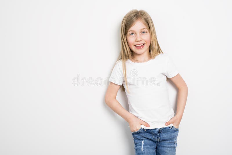 Piccoli cinque anni felici della ragazza con capelli diritti sopra fondo bianco a casa immagine stock libera da diritti Piccoli cinque anni felici della ragazza con capelli diritti sopra fondo bianco a casa immagine stock libera da diritti