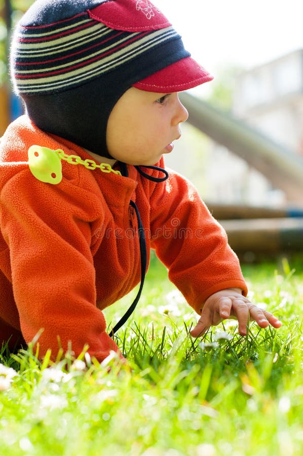 Piccolo neonato che cammina e che esplora il parco fotografia stock libera da diritti Piccolo neonato che cammina e che esplora il parco fotografia stock libera da diritti